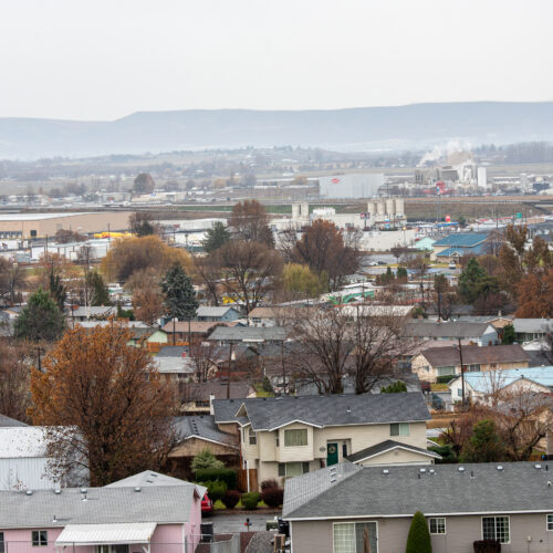 An aerial view of the city of Sunnyside, Washington. Houses and trees are in view.