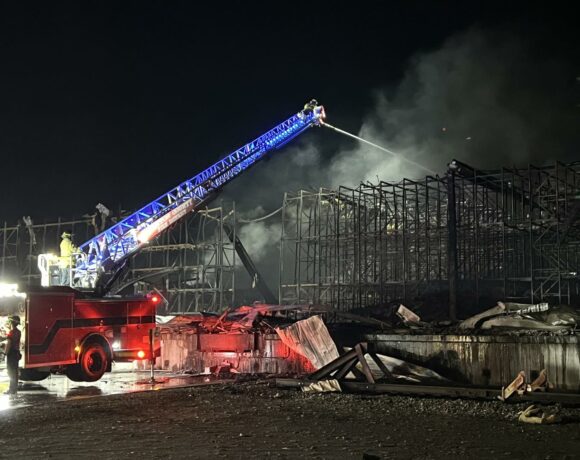 Fire crews spray water on rubble at the Lineage Logistics fire in Finley, Washington. The fire started on April 21. (Credit: Benton County Fire District #1)