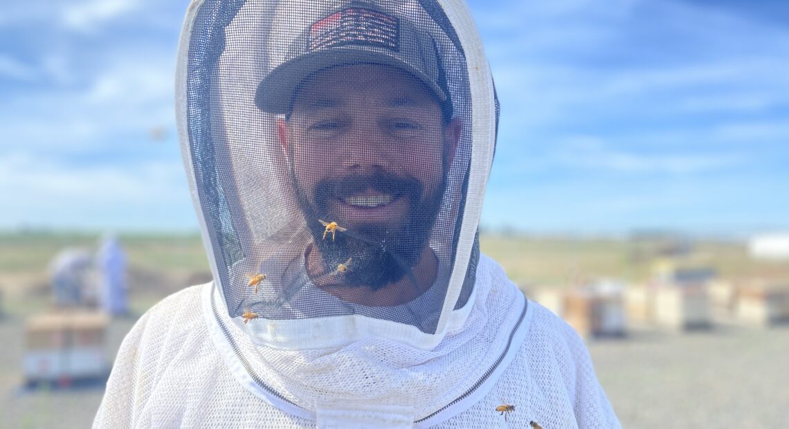 Brandon Hopkins, 42, with Washington State University, stands in front of the university’s bee colonies at a facility in Othello, Washington, where he and a team were examining the hives.