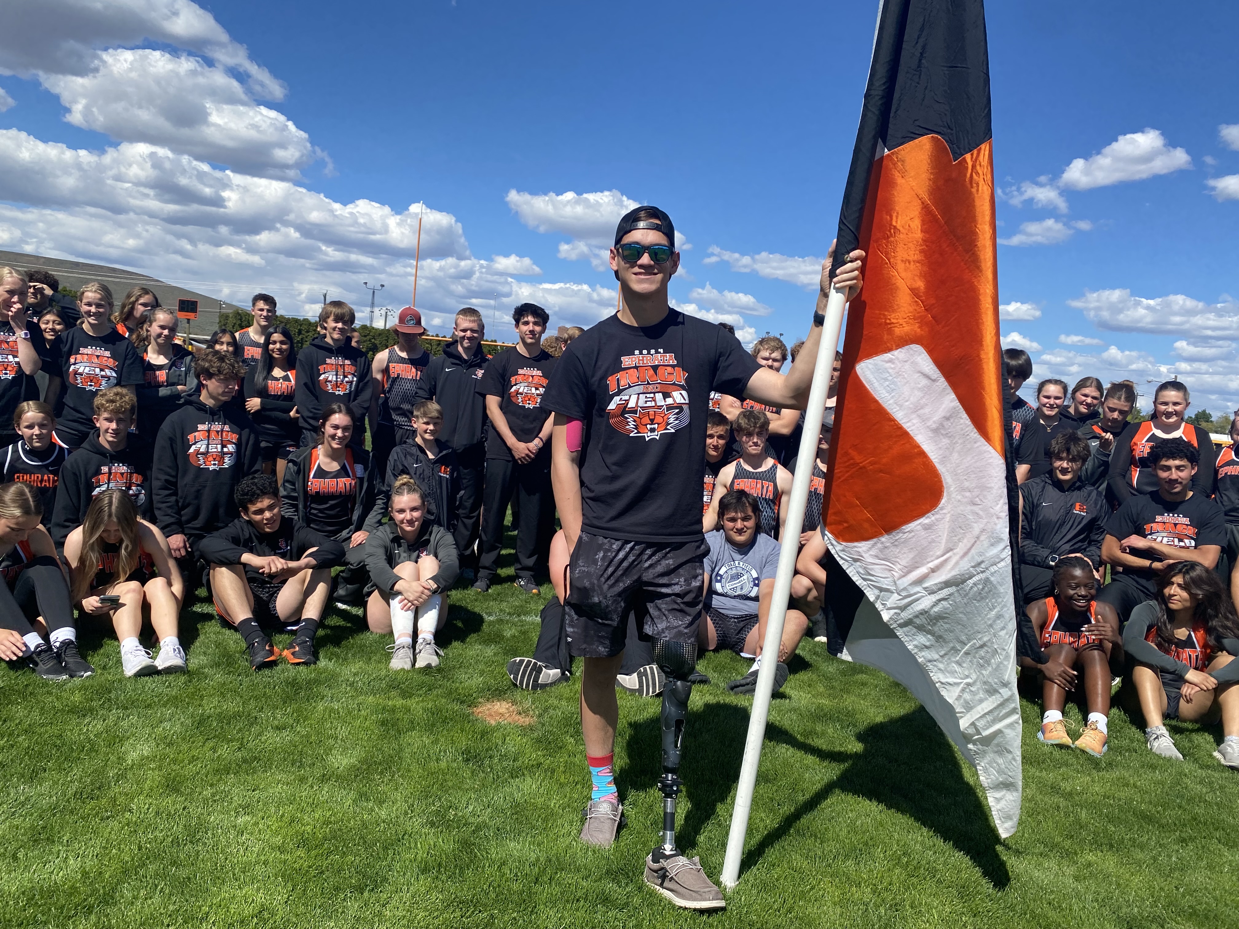 Ben Belino holds the Tiger’s flag May 2 in front of the Ephrata High School track and field team. 