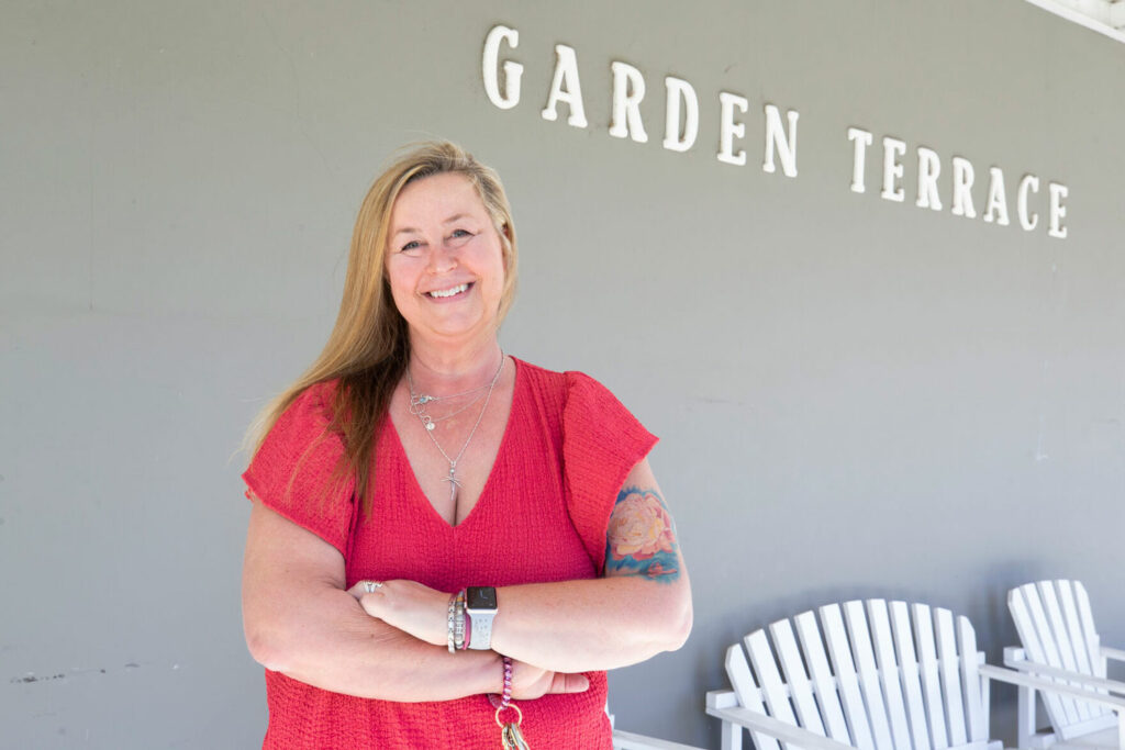 Shawna Smith, a manager at Garden Terrace, poses for a photo outside the building. (Credit: Jacob Ford / Wenatchee World)