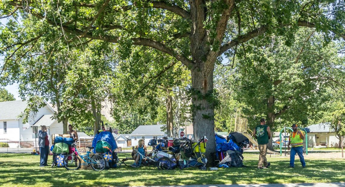 People stand by their belongings at Foster Park in Clarkston on June 3.