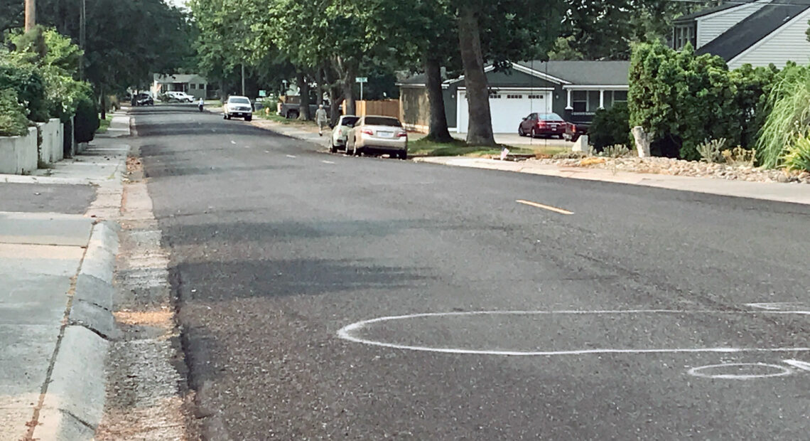 White graffiti marks are pictured on the middle of the road in a north Richland neighborhood.