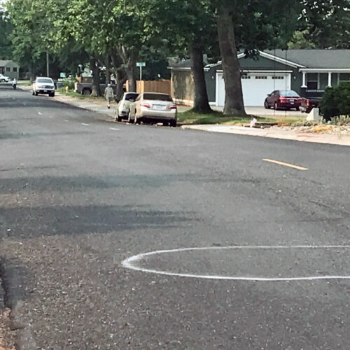 White graffiti marks are pictured on the middle of the road in a north Richland neighborhood.
