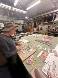 Miller is working on a sculpture of dinosaur bones that will be hidden under sand, for museum visitors to uncover. (Credit: Lauren Gallup / NWPB)