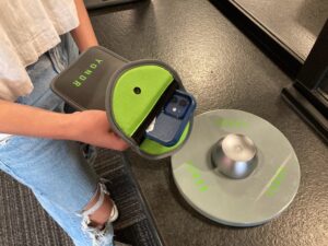 A student holds her phone pouch over the Yondr magnet.