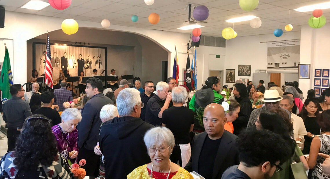 Members of the Filipino community enjoy traditional music and dishes during the celebration at the Filipino Community Hall of the Yakima Valley in Wapato (Credit: Johanna Bejarano / NWPB).