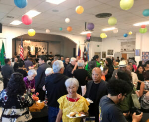 Members of the Filipino community enjoy traditional music and dishes during the celebration at the Filipino Community Hall of the Yakima Valley in Wapato (Credit: Johanna Bejarano / NWPB).