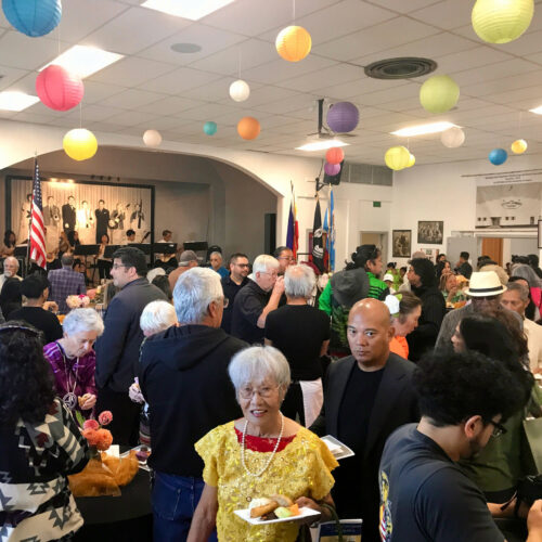 Members of the Filipino community enjoy traditional music and dishes during the celebration at the Filipino Community Hall of the Yakima Valley in Wapato (Credit: Johanna Bejarano / NWPB).