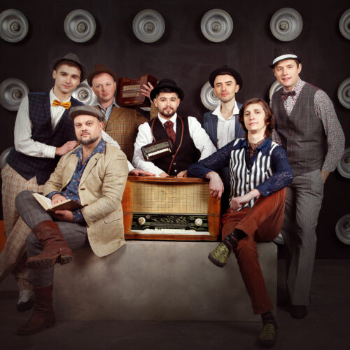 Seven members of a Ukrainian band look at the camera.