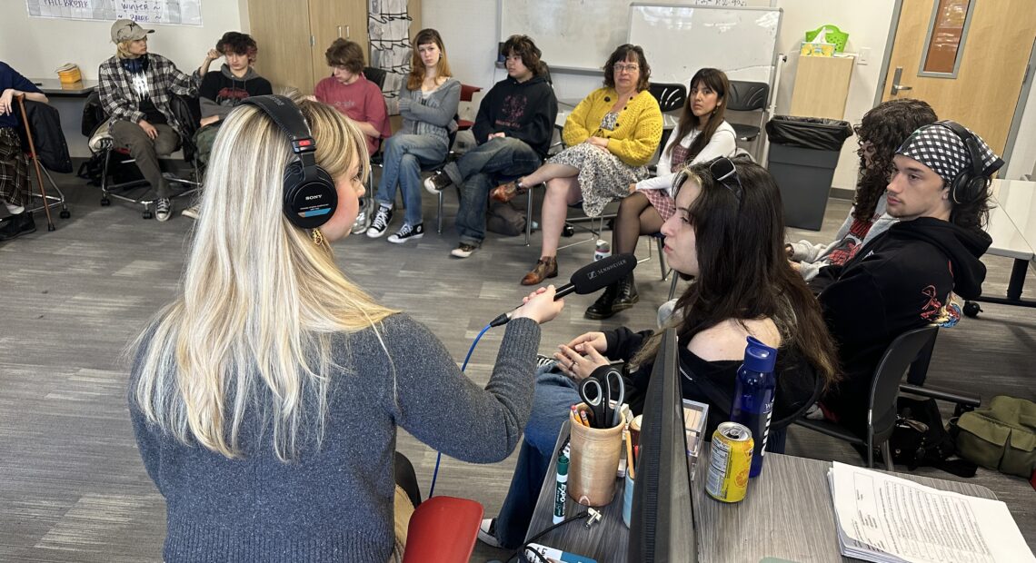 Reporter Lauren Gallup interviews student Valentina Forero and others in a senior civics class at the Tacoma School of the Arts. Credit: Jordan Villalpando, Tacoma teacher.