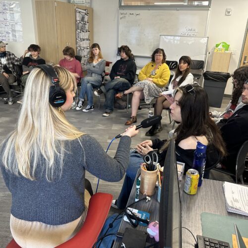 Reporter Lauren Gallup interviews student Valentina Forero and others in a senior civics class at the Tacoma School of the Arts. Credit: Jordan Villalpando, Tacoma teacher.