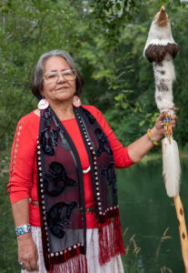 a portrait of a woman holding an eagle staff