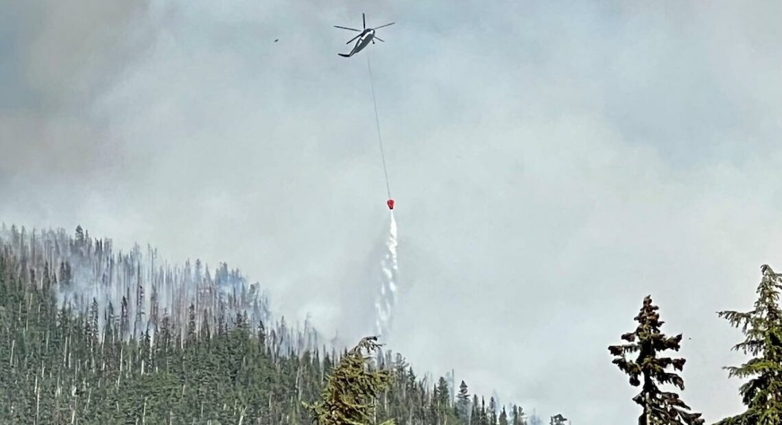 An aircraft drops water on the Easy Fire in Wenatchee in July.