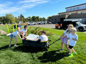 Students with the Kids for Urban Trees club get ready to plant trees at Tapteal Elementary School in West Richland. (Credit: Courtney Flatt / NWPB)