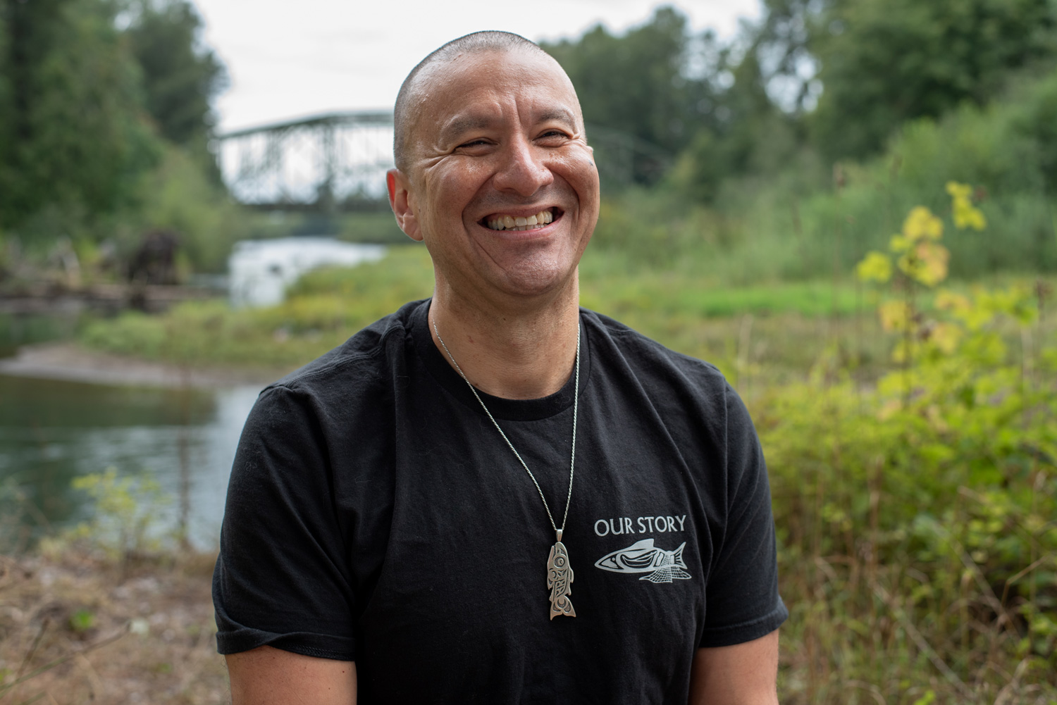 portrait of a man smiling near a river