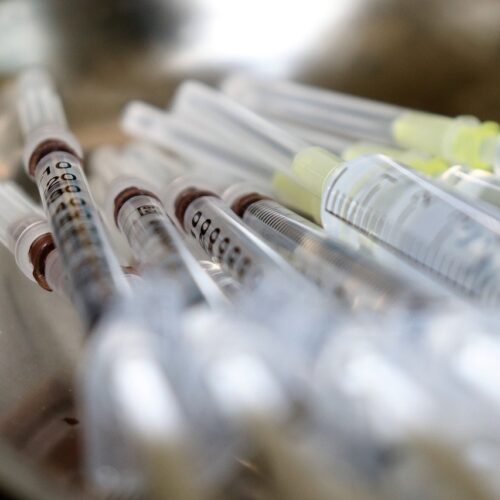 A close-up of vaccination syringes.