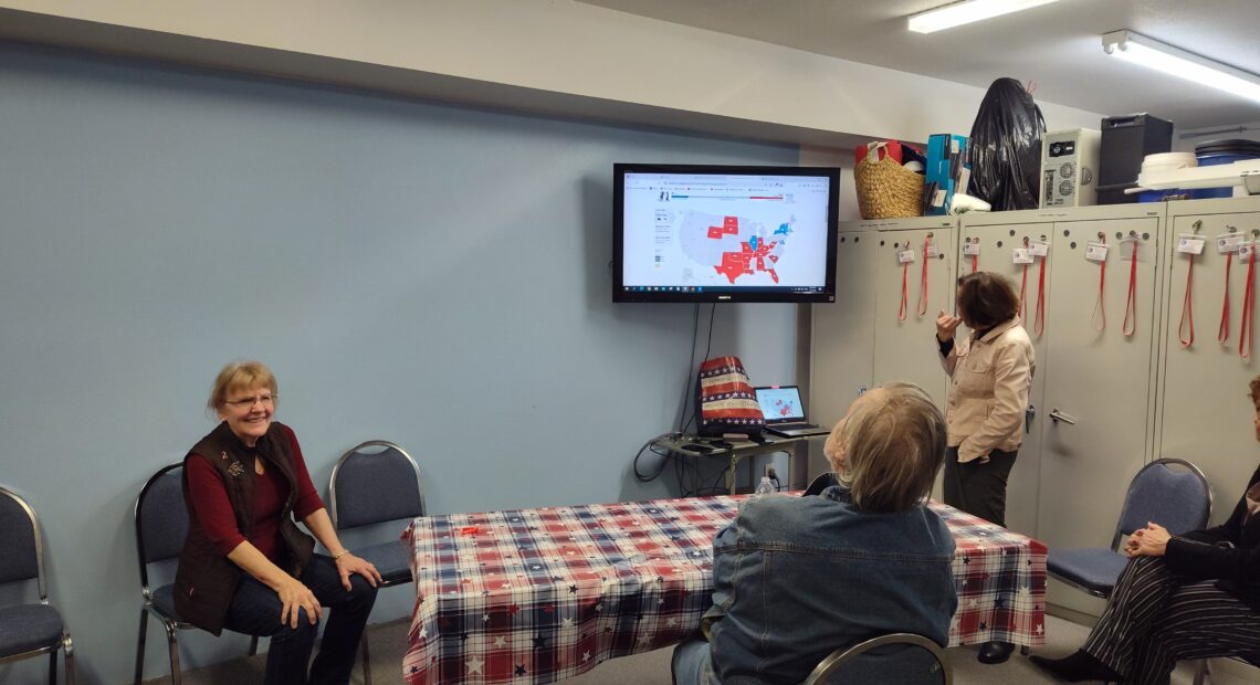 Clallam County Republican Party Chair Pam Blakeman, sits next to a screen showing early results in the 2024 presidential race.(Courtesy of Pam Blakeman)