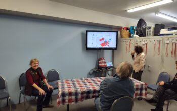 Clallam County Republican Party Chair Pam Blakeman, sits next to a screen showing early results in the 2024 presidential race.(Courtesy of Pam Blakeman)