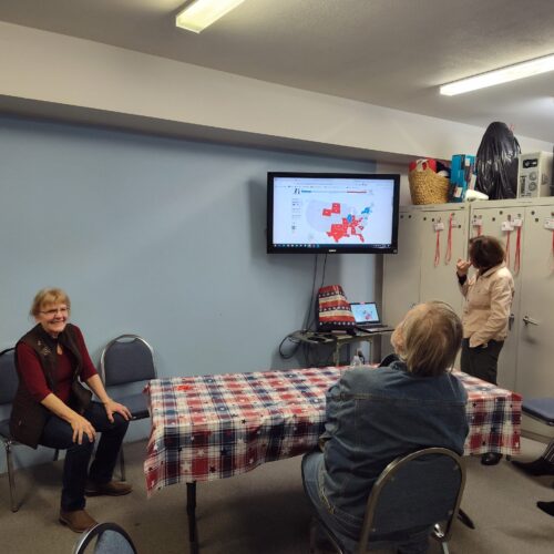 Clallam County Republican Party Chair Pam Blakeman, sits next to a screen showing early results in the 2024 presidential race.(Courtesy of Pam Blakeman)