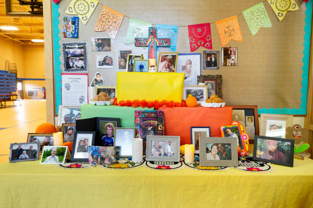 An ofrenda is pictured for the Día de los Muertos holiday. Pictures and flowers are displayed.