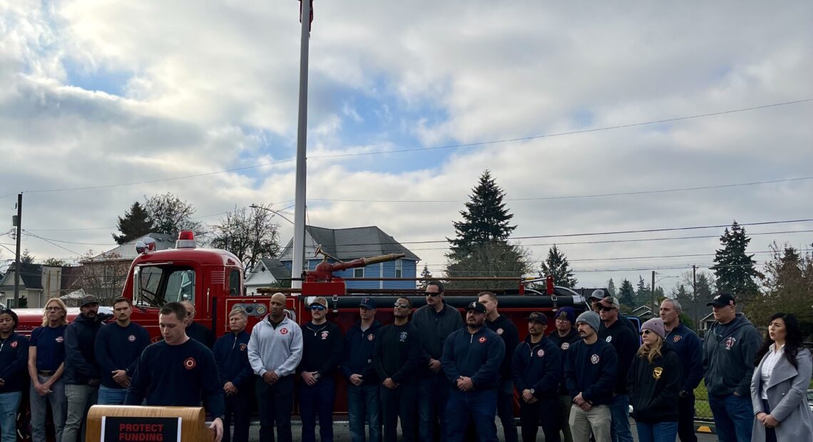 Tacoma firefighter, Ryan Pregent, spoke to a crowd gathered for a press conference on Monday, Dec. 2. (Credit: Lauren Gallup // NWPB)