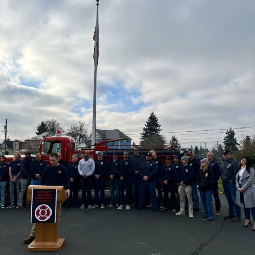 Tacoma firefighter, Ryan Pregent, spoke to a crowd gathered for a press conference on Monday, Dec. 2. (Credit: Lauren Gallup // NWPB)