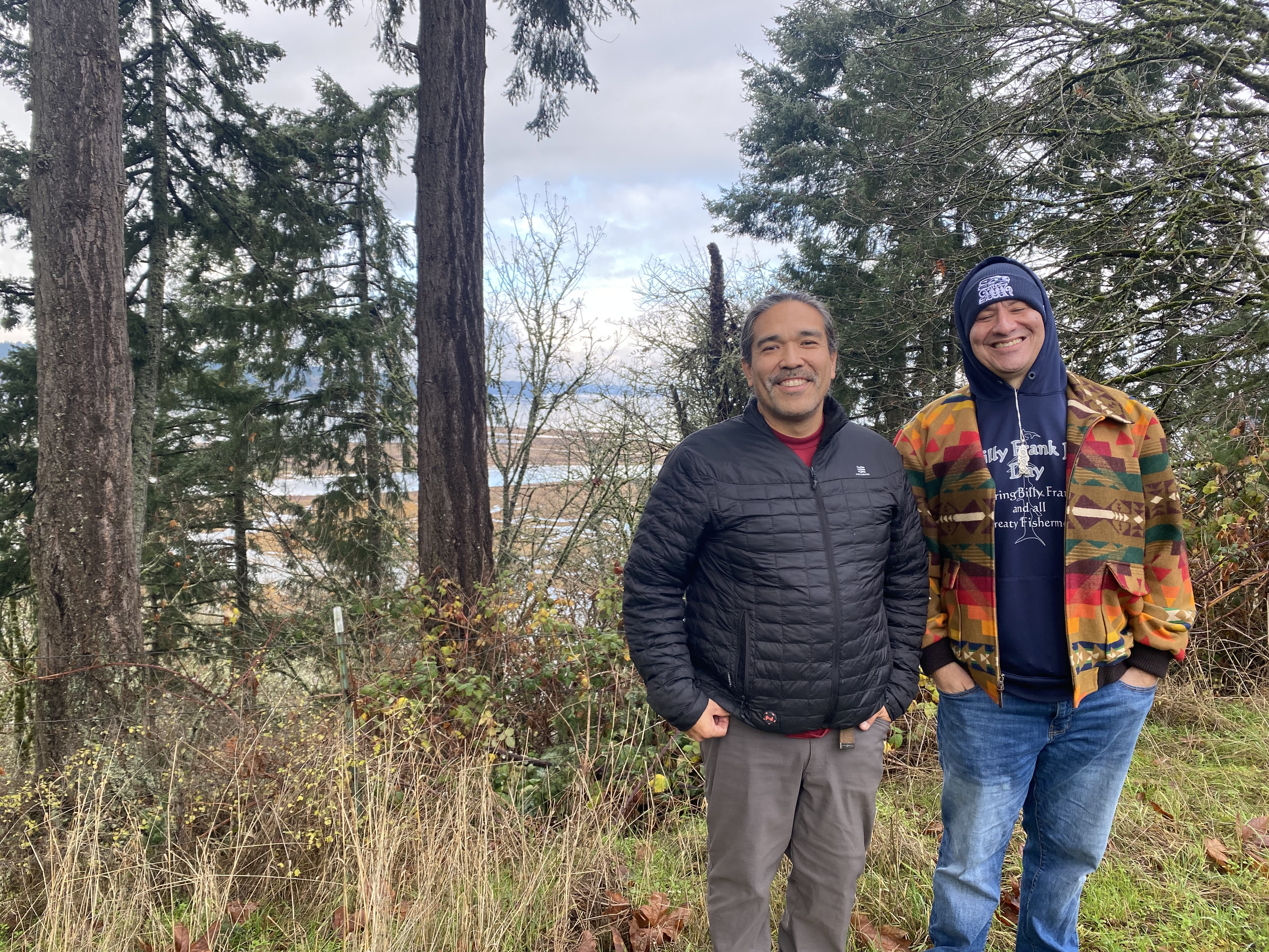 Hanford McCloud, left, and Wille Frank III, stand on a bluff above the Nisqually River delta that pours into the south Puget Sound.