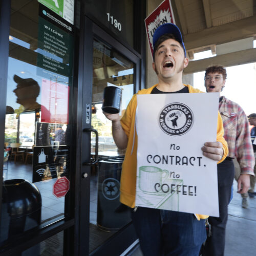 Starbucks workers picket outside of a closed Starbucks on Friday, Dec. 20, 2024, in Burbank, Calif. After the largest strike from the company in it's history, workers have yet to reach a collective bargaining agreement with Starbucks.(AP Photo/Damian Dovarganes)