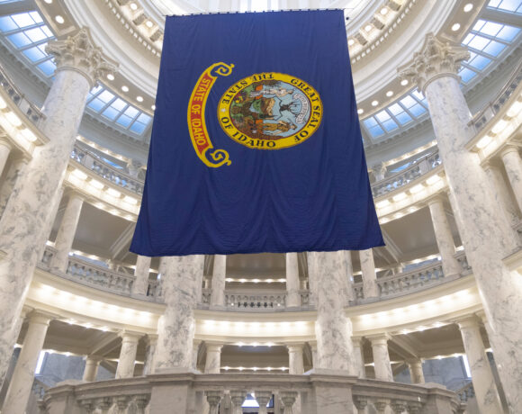 Idaho's blue state flag hangs from the ceiling in the state capital building.