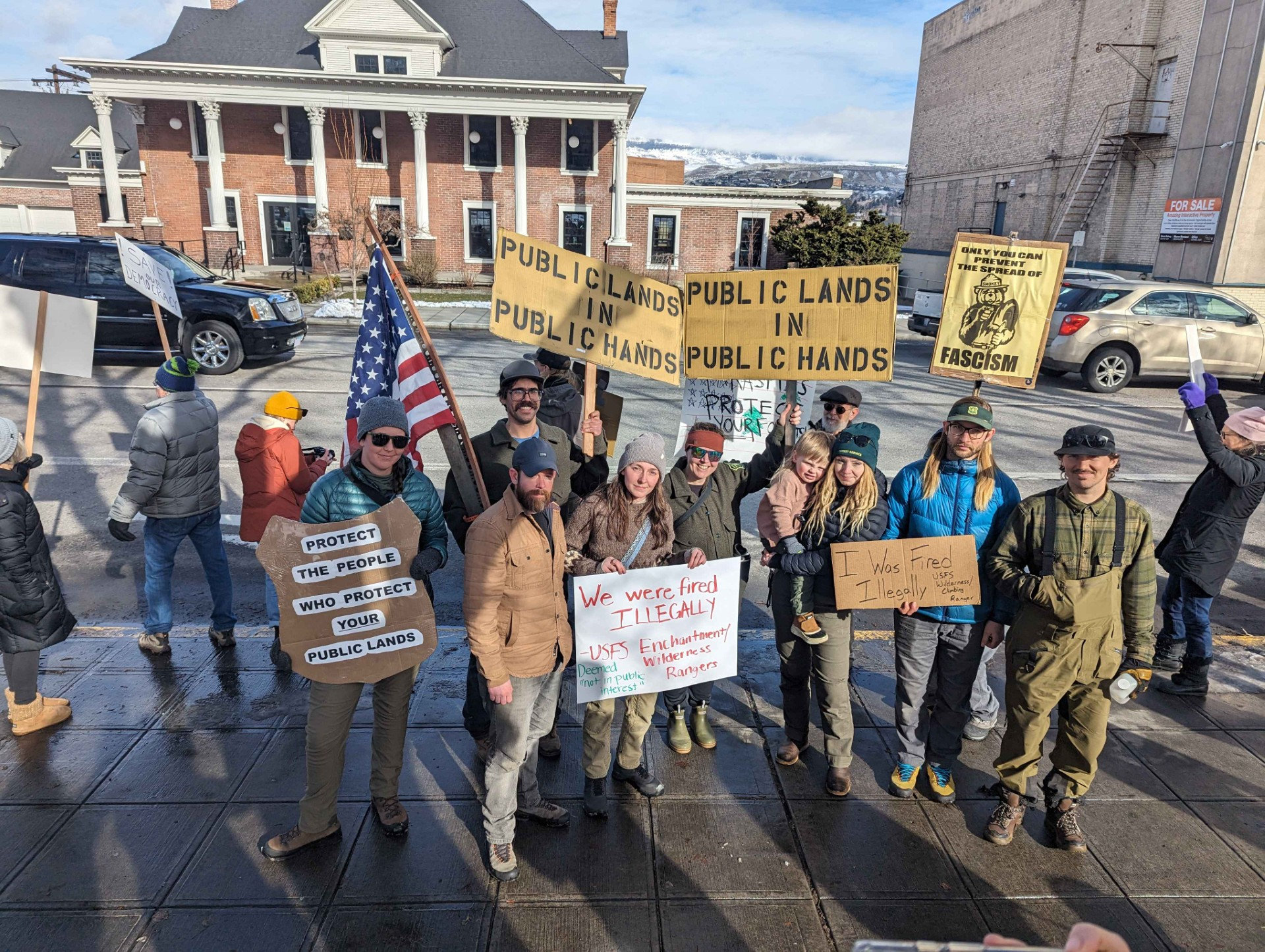 Employees fired from National Parks across Washington protest their terminations at Memorial Park in downtown Wenatchee, Washington, holding handmade signs. 