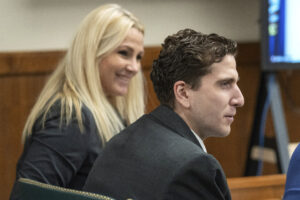 Bryan Kohberger wears a grey suit and sits next to his attorney Anne Taylor, who also wears a grey suit and has blonde hair, in a Latah County Courtroom.