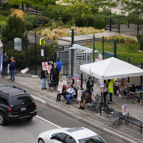 Boeing workers wave picket signs at passing cars as they strike Tuesday, Sept. 24, 2024, near the company's factory in Renton, Wash. If Washington state passes the proposed legislation, striking workers, after a waiting period, could receive unemployment benefits. (AP Photo/Lindsey Wasson)