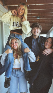 A photo shows the four students who were killed. Madison Mogen sits on Kaylee Goncalves' shoulders, with Kernodle and Chapin beside them. 